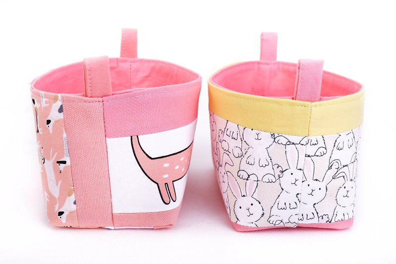 side view of small pink storage baskets for kids, made with cute sausage dog and bunny print, by MIMI Handmade Baskets Australia