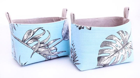 set of two blue and grey storage baskets made with botanical monstera leaf fabric handmade by MIMI Handmade