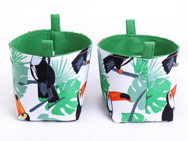 Side view of set of two green tropical toucan fabric decorative storage baskets by MIMI Handmade Baskets, Australia