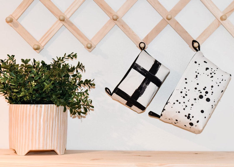 small and medium black monochrome fabric storage baskets hanging on a hook next to a plant, wall storage organiser, monochrome homewares, boho chic home decor, handmade in Australia by MIMI Handmade