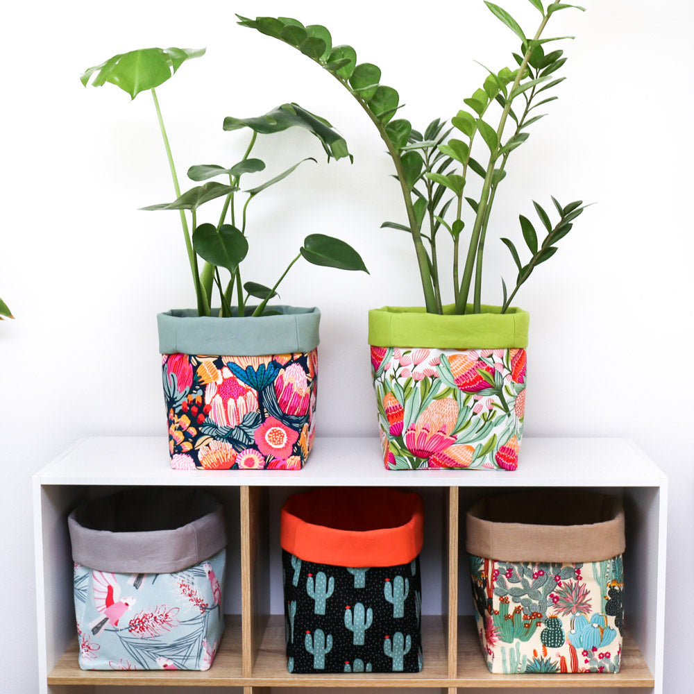 Load image into Gallery viewer, cube-shelving-unit-displaying-two-houseplants-in-colourful-canvas-pot-covers-and-botanical-square-foldable-decorative-fabric-storage-baskets-by-MIMI-Handmade
