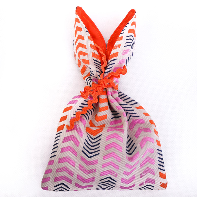 orange-and-pink-bunny-ear-bag-arrow-fabric-print