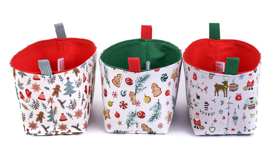 side-view-of-3-small-decorative-Christmas-baskets-featuring-gingerbread-men-Christmas-cookies-Santa-and-Xmas-tree