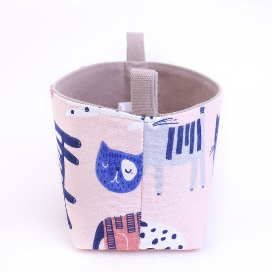 side view of small handmade pink kawaii cat drawings decorative storage basket, made in Australia by MIMI Handmade Baskets
