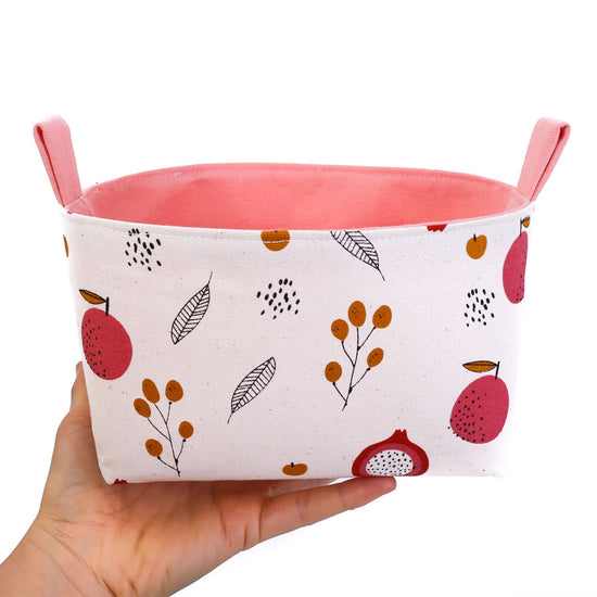 woman-hand-holding-a-cream-and-pink-dragon-fruit-print-decorative-basket